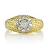 A DIAMOND CLUSTER DRESS RING, CIRCA 1970 set with a central round brilliant cut diamond encircled by