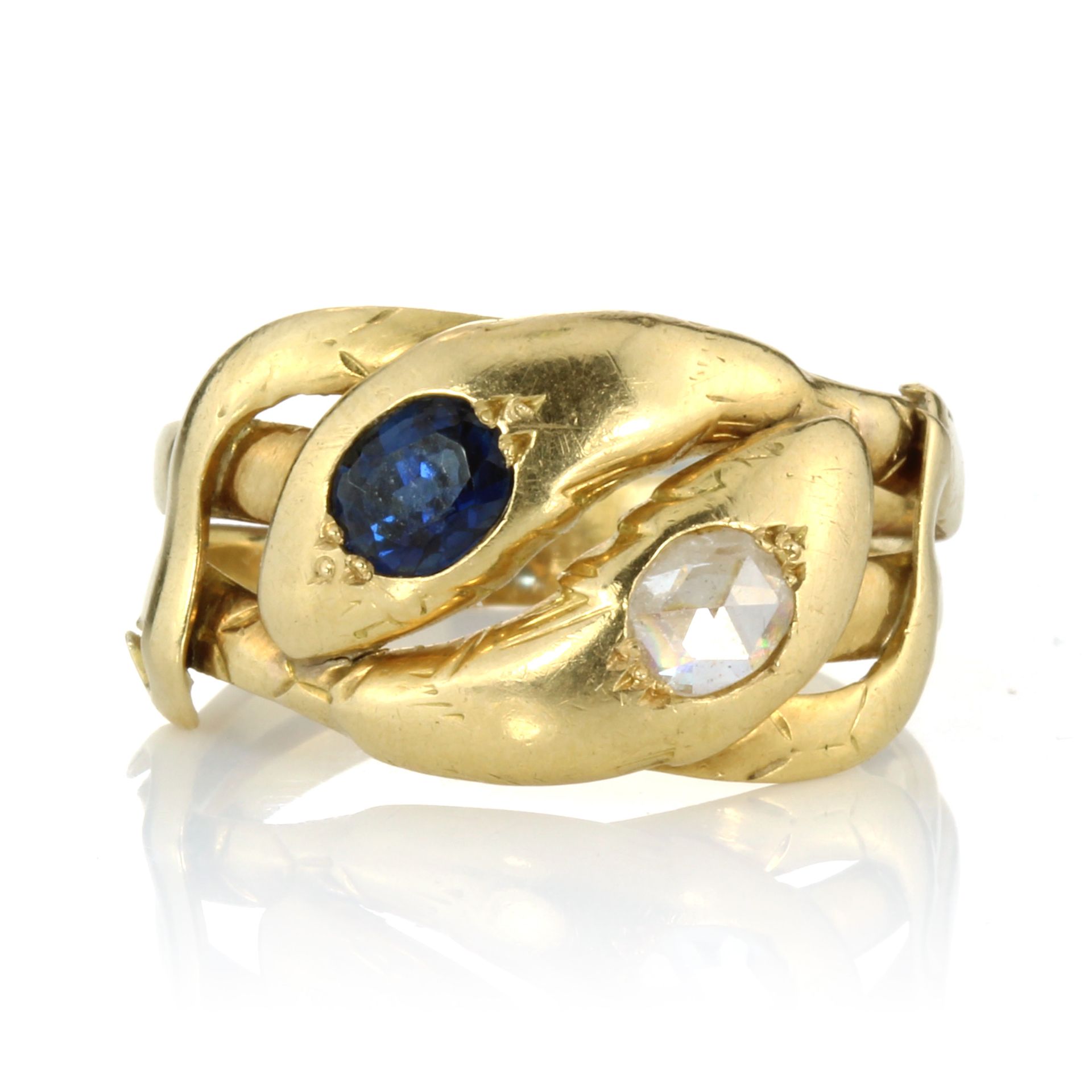 A SAPPHIRE AND DIAMOND DOUBLE HEADED SNAKE RING, CIRCA 1910 designed as two snakes, their bodies