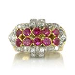 A RUBY AND DIAMOND COCKTAIL RING set with two rows of round cut rubies within a surround of round