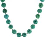 AN CHINESE CARVED TURQUOISE BEAD NECKLACE comprising a single row of thirty one carved turquoise