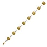 AN ANTIQUE ART NOUVEAU DIAMOND BRACELET designed as sixteen alternating links with floral designs