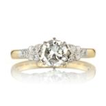 A DIAMOND DRESS RING set with a central round cut diamond of 0.90 carats between jewelled floral