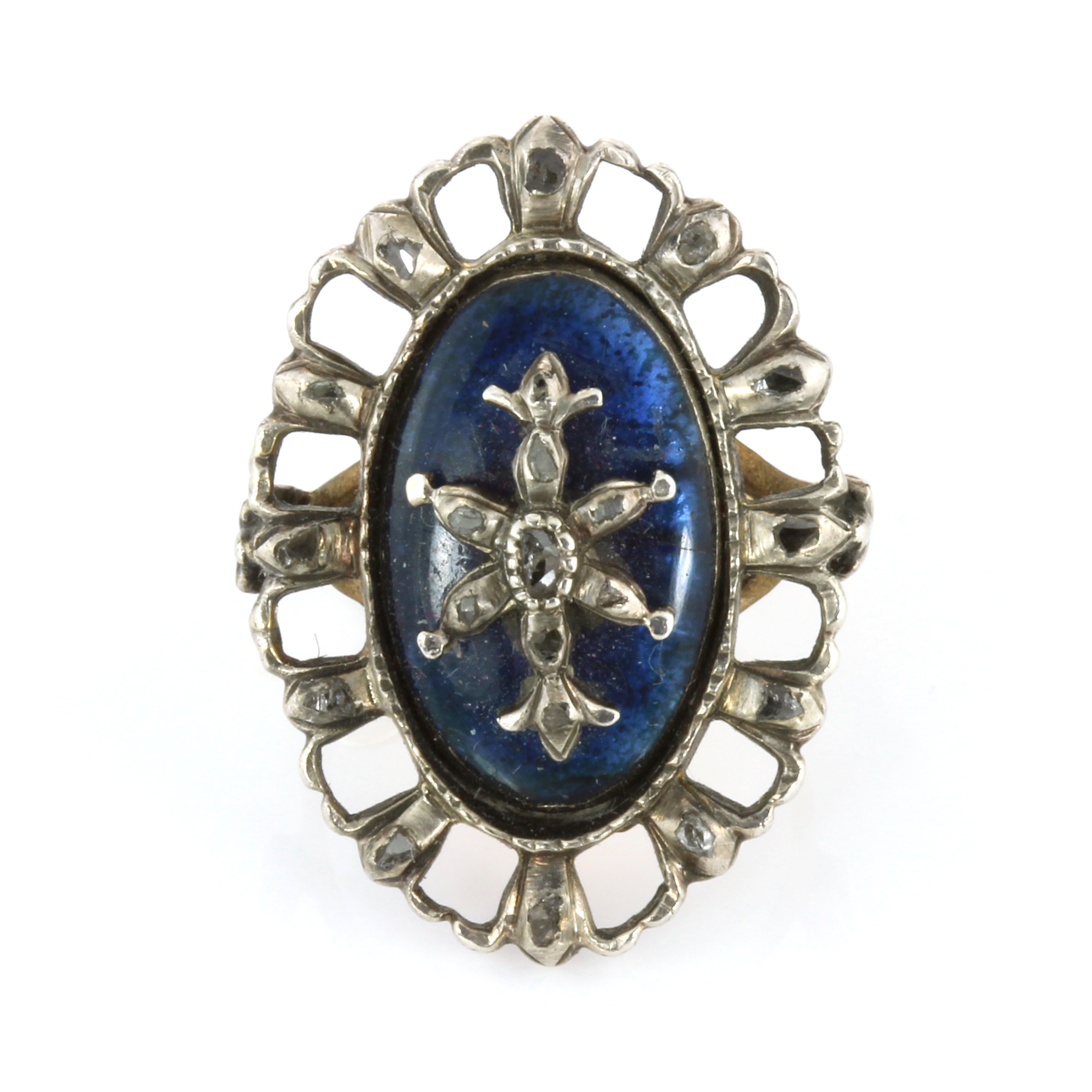 AN ANTIQUE DIAMOND AND BLUE GLASS RING set with a navette French blue glass panel overlaid with a