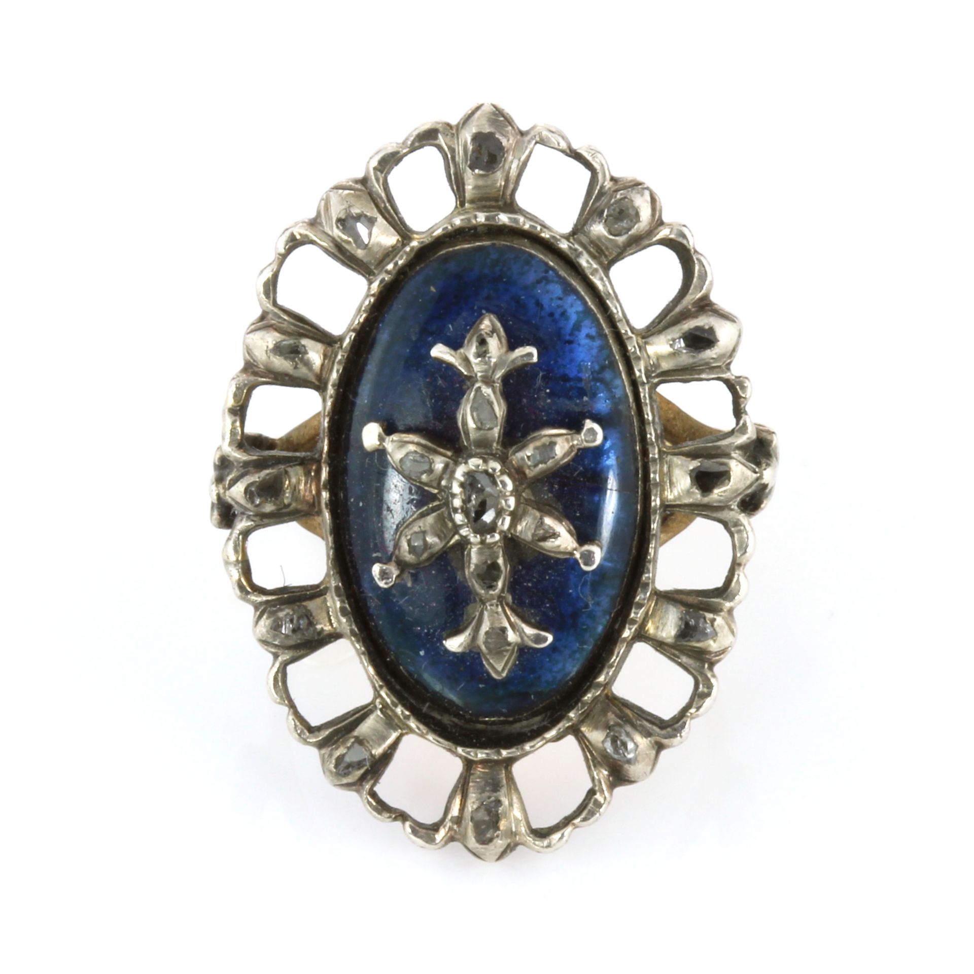 AN ANTIQUE DIAMOND AND BLUE GLASS RING set with a navette French blue glass panel overlaid with a