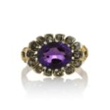 AN ANTIQUE AMETHYST AND DIAMOND DRESS RING, 19TH CENTURY set with an oval cut amethyst surrounded by