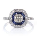 AN ART DECO DIAMOND AND SAPPHIRE RING set with a central Asscher cut diamond of 0.52 carats,