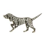 A DIAMOND DOG BROOCH modeled as a dog, walking with its tail and paw raised, jewelled all over the