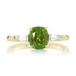 A DEMANTOID GARNET AND DIAMOND THREE STONE RING set with a central cushion cut demantoid garnet of