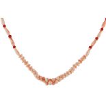 A CORAL AND ANGEL CORAL BEAD NECKLACE designed as a single row of graduated interlocking angel coral