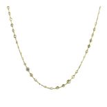 A YELLOW DIAMOND LONGCHAIN NECKLACE designed as a single row of one hundred bezel set old round