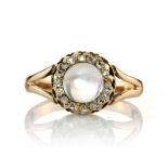 AN ANTIQUE MOONSTONE AND DIAMOND DRESS RING set with a central cabochon moonstone encircled by