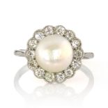 A NATURAL SALTWATER PEARL AND DIAMOND CLUSTER RING, EARLY 20TH CENTURY designed as a central