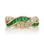 AN EMERALD AND DIAMOND RING, TIFFANY & CO designed as two interwoven bands set with round cut