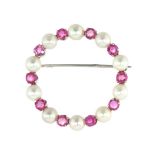 A PINK SAPPHIRE AND PEARL BROOCH, EARLY-MID 20TH CENTURY designed as a full circle set with