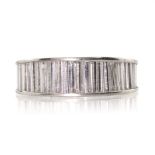 A DIAMOND ETERNITY RING set with a full band of graduated baguette cut diamonds. Ring size O / 7.