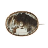 AN ANTIQUE HAIRWORK MINIATURE MOURNING BROOCH, 19TH CENTURY of oval form with a scene depicted in