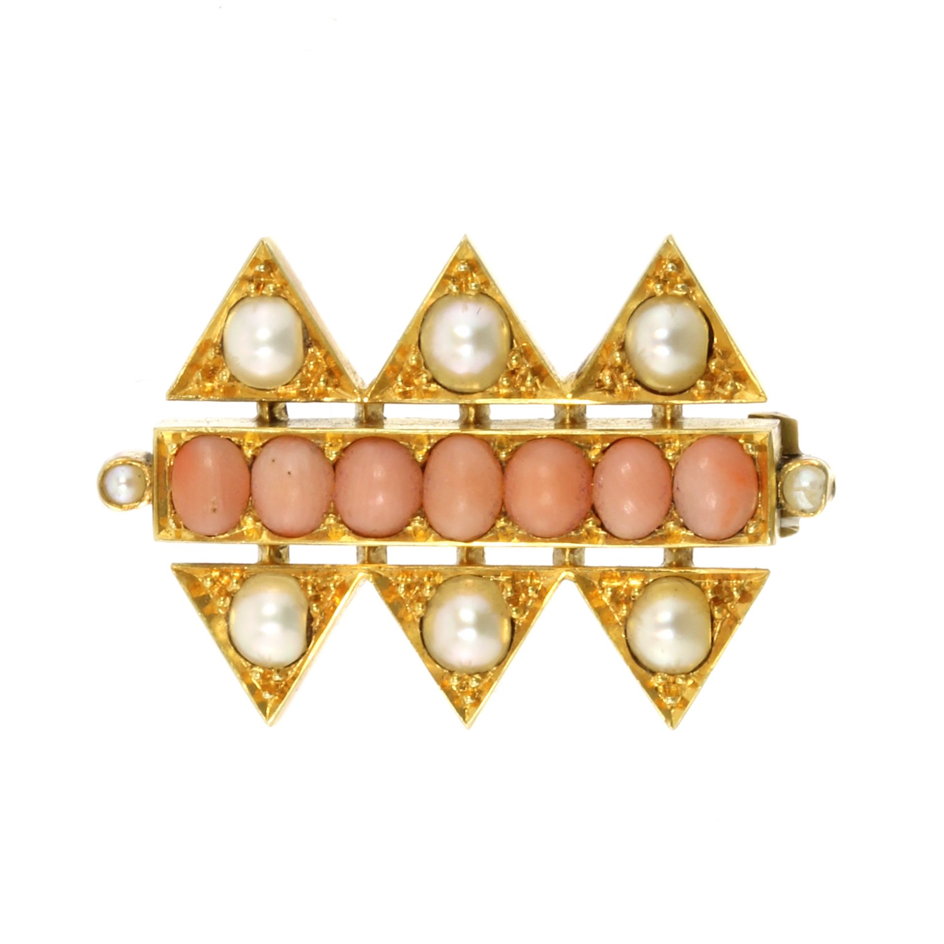 AN ANGEL CORAL AND PEARL BROOCH set with a single row of angel coral cabochons flanked above and