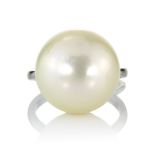 A LARGE PEARL DRESS RING set with a single pearl of 15.75mm in diameter in a plain shank, stamped