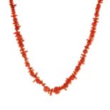 A CORAL BEAD AND TWIG NECKLACE comprising a single row of graduated polished round coral beads and
