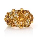 A CITRINE, YELLOW DIAMOND AND DIAMOND COCKTAIL RING of bombe form, set with circular citrine