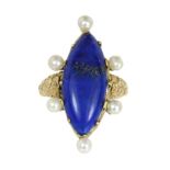 A LAPIS LAZULI AND PEARL DRESS RING set with a large marquise cabochon lapis lazuli surrounded by