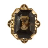 A SMOKY QUARTZ COCKTAIL RING set with a large emerald cut smoky quartz of 37.38 carats within a