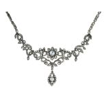 A FINE ANTIQUE ROSE CUT DIAMOND NECKLACE in high carat yellow gold and silver, the central motif set