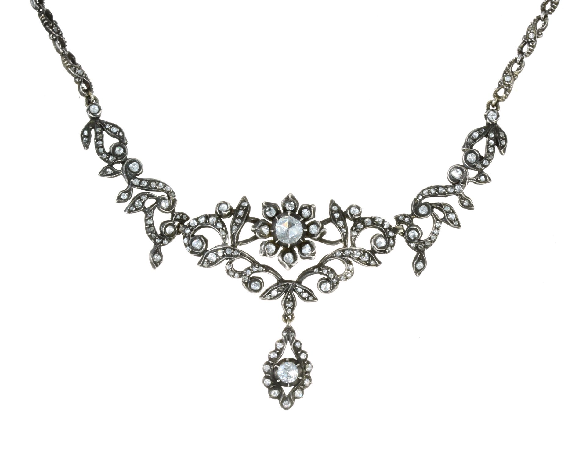 A FINE ANTIQUE ROSE CUT DIAMOND NECKLACE in high carat yellow gold and silver, the central motif set