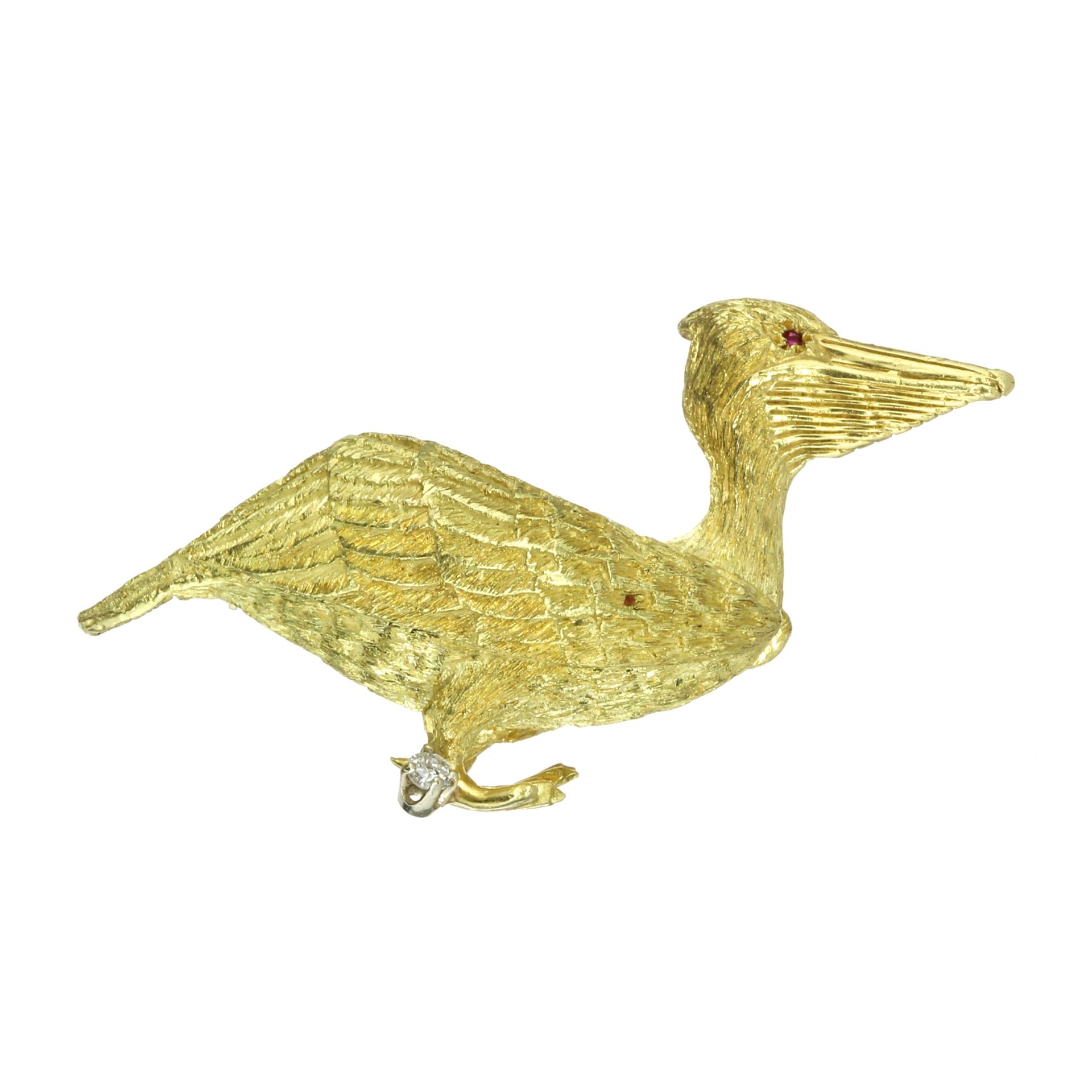 A RUBY AND DIAMOND PELICAN BROOCH, MAURICE GUYOT in 18ct yellow gold, in the form of a pelican, cast