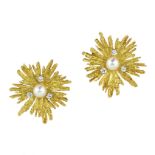 A PAIR OF PEARL AND DIAMOND EARRINGS in 18ct yellow gold each set with a central pearl surrounded by