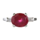 A RUBY AND DIAMOND DRESS RING in white gold or platinum, set with a central oval cut ruby of 2.51