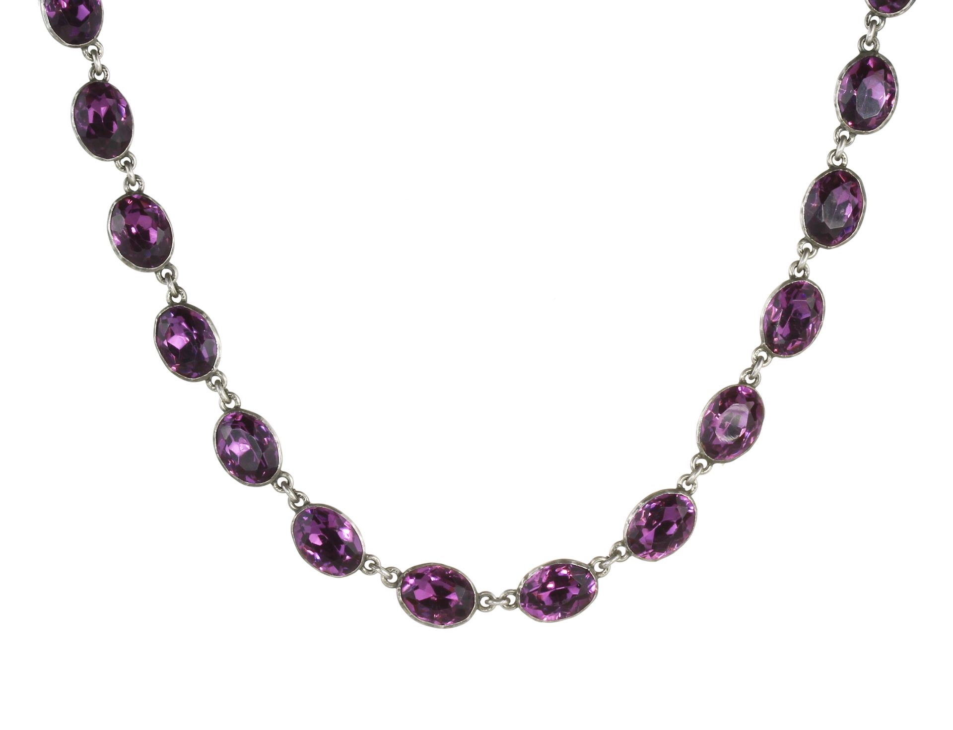 AN ANTIQUE AMETHYST RIVIERA NECKLACE in silver, comprising a single row of twenty-two oval cut