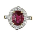 A RUBY AND DIAMONG CLUSTER RING in high carat yellow gold, set with a central oval cut ruby of 3.