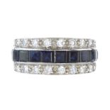 A BLUE SAPPHIRE AND DIAMOND HALF ETERNITY RING in 18ct white gold set with a central row of step cut