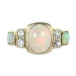 AN ANTIQUE OPAL AND DIAMOND DRESS RING in high carat yellow gold set with a central oval cabochon