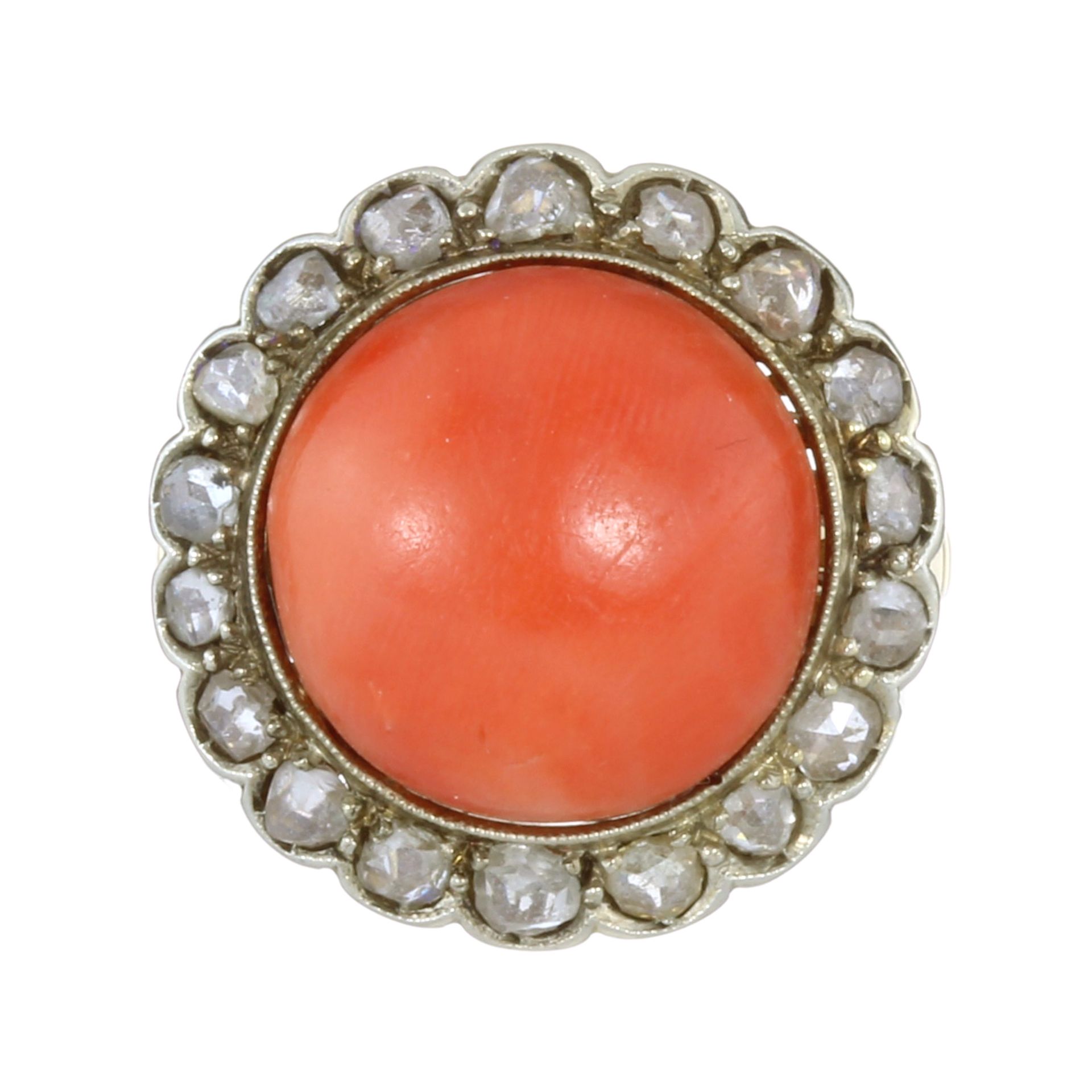 AN ANTIQUE CORAL AND DIAMOND CLUSTER RING in high carat yellow gold and silver set with a central