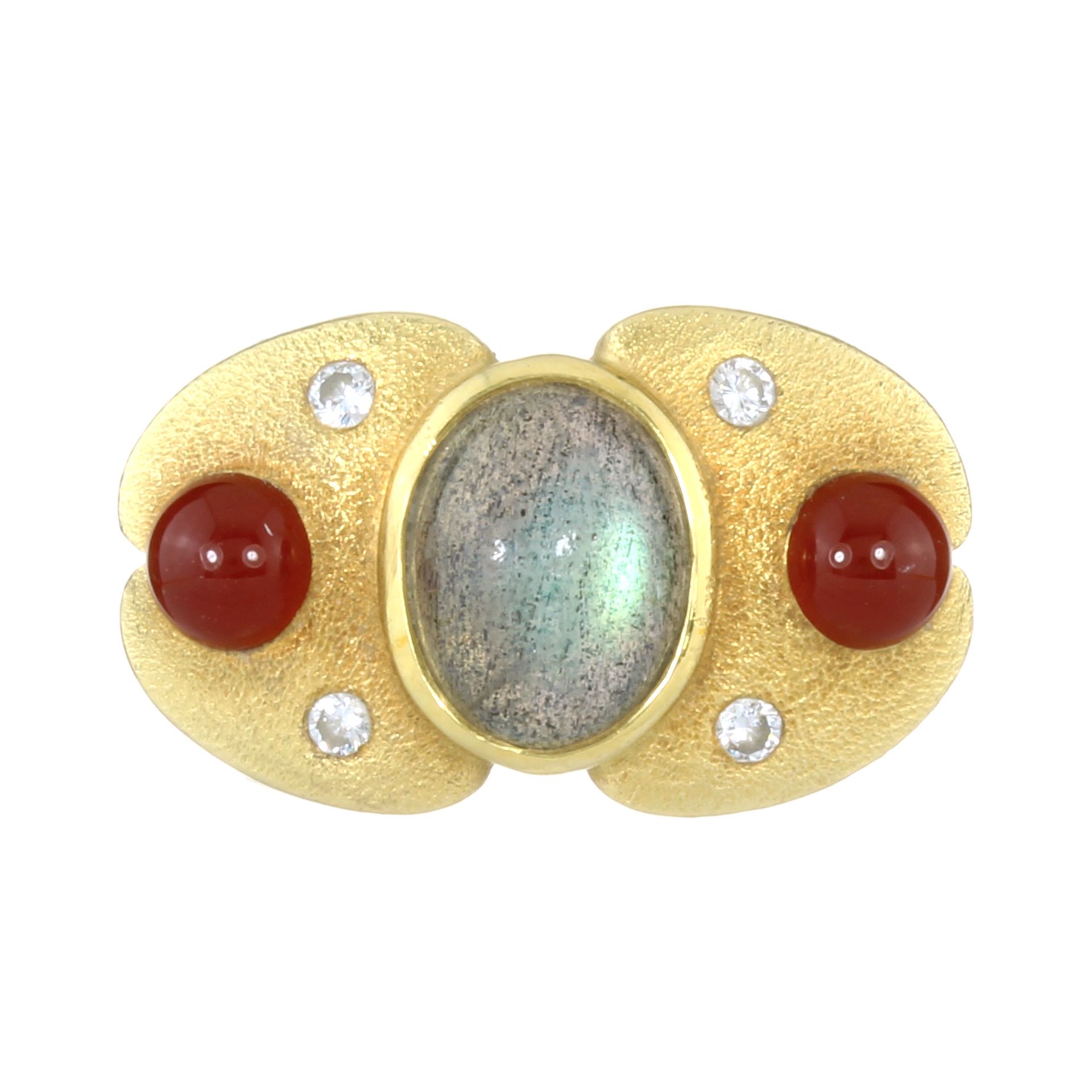 A LABRADORITE, CARNELIAN AND DIAMOND DRESS RING in high carat yellow gold, set with a central oval