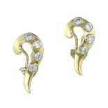 A PAIR OF DIAMOND CLIP EARRINGS in high carat yellow gold each designed as a scrolling motif set