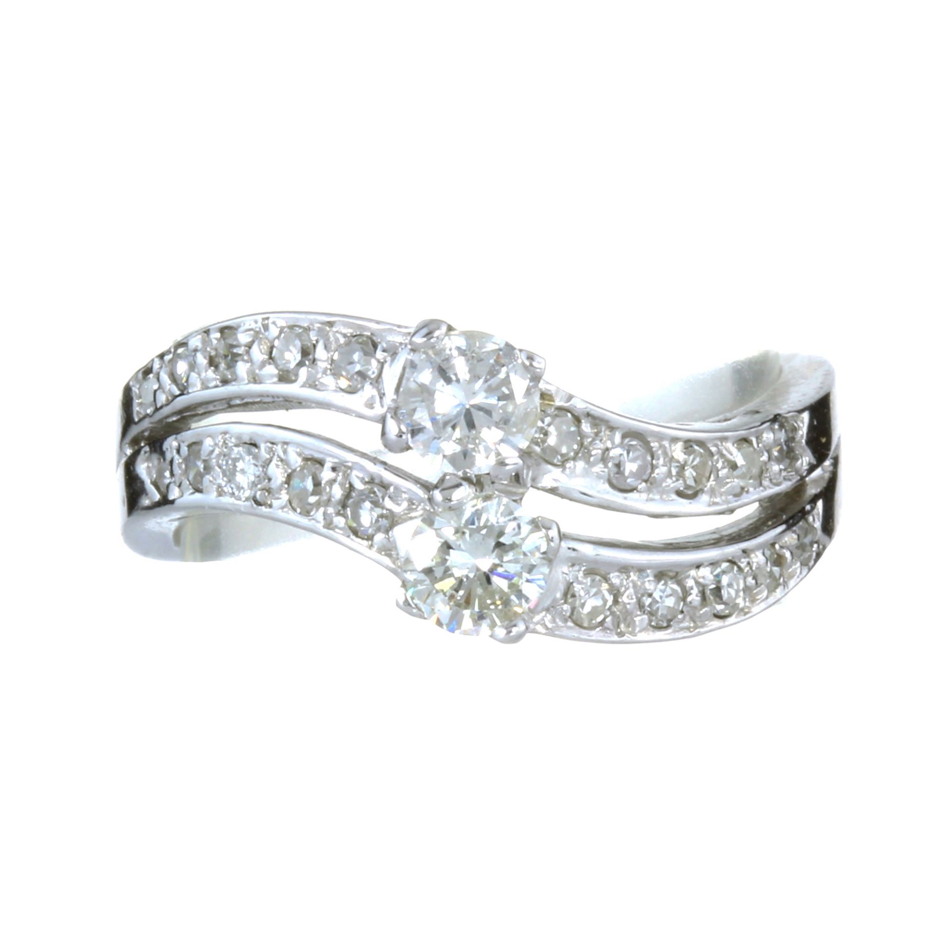 A DIAMOND DRESS RING in white gold or platinum designed as a split band each half set with a central