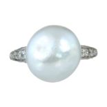 A 12.7MM NATURAL SALTWATER PEARL AND DIAMOND RING in white gold or platinum set with a central pearl