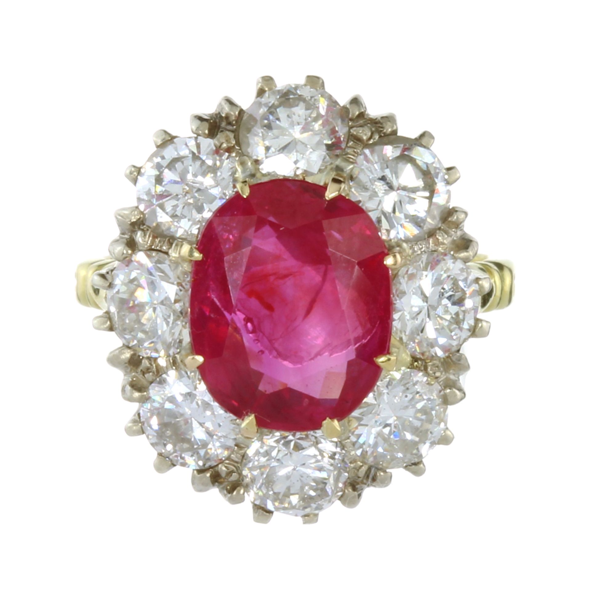 A 4.44 CARAT BURMA NO HEAT RUBY AND DIAMOND RING in yellow gold set with an oval cut ruby of 4.44