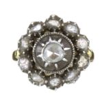 AN ANTIQUE ROSE CUT DIAMOND CLUSTER RING in high carat yellow gold and silver set with a central