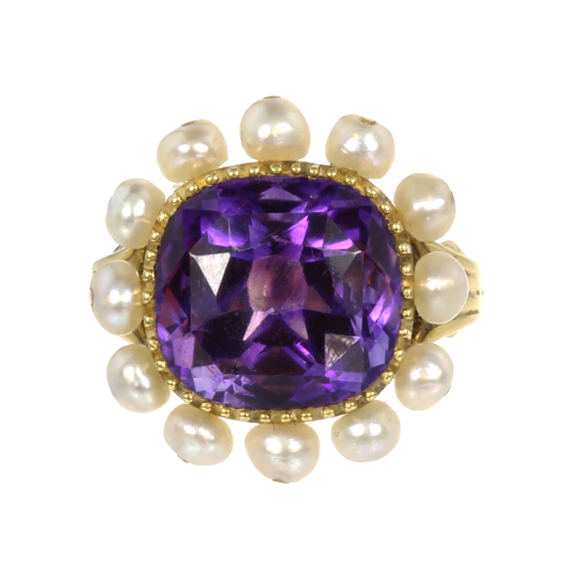 AN AMETHYST AND PEARL DRESS RING set with a central cushion cut amethyst of 8.37 carats within a