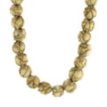AN ANTIQUE JAPANESE OJIME BEAD NECKLACE comprising a single row of thirty carved ivory ojime beads