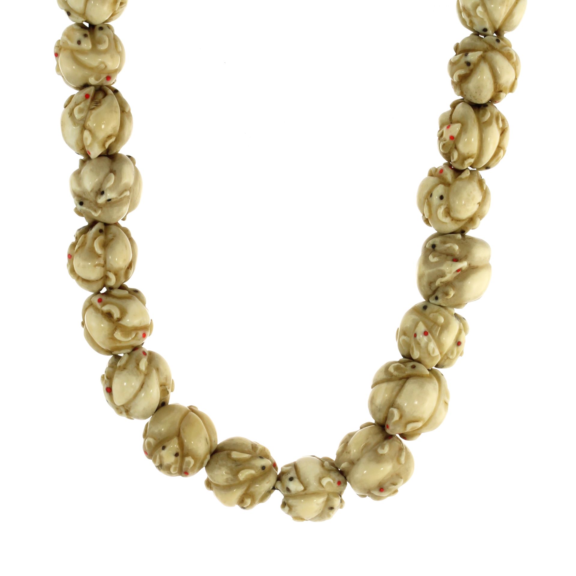 AN ANTIQUE JAPANESE OJIME BEAD NECKLACE comprising a single row of thirty carved ivory ojime beads