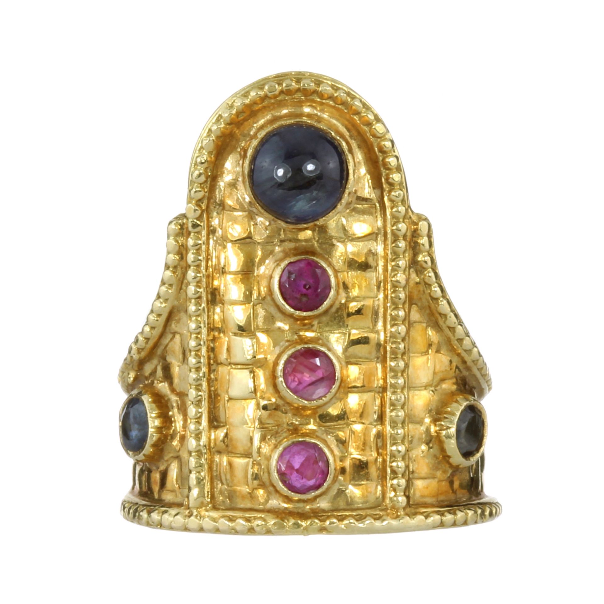 A VINTAGE RUBY AND SAPPHIRE DRESS RING, LALAOUNIS in 18ct yellow gold with a cobbled textured