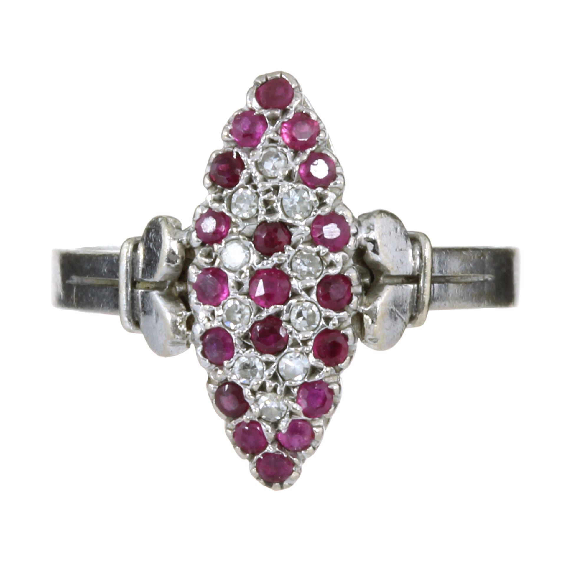 A DIAMOND AND RUBY DRESS RING in 18ct white gold, the navette shaped face jewelled with concentric