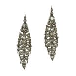 A PAIR OF ANTIQUE DIAMOND EARRINGS in high carat gold and silver, the elongated body with