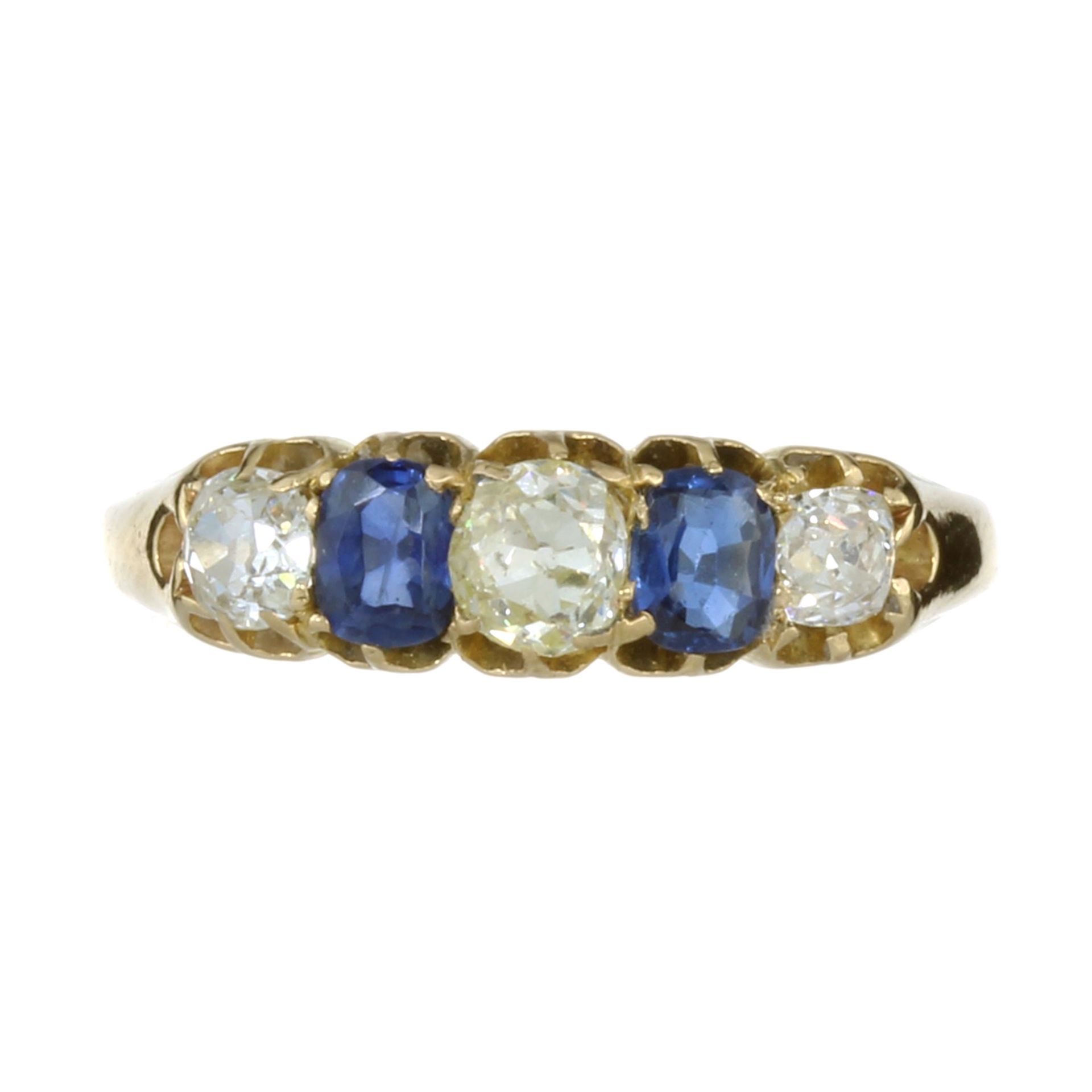 AN ANTIQUE DIAMOND AND BLUE SAPPHIRE FIVE STONE RING in high carat yellow gold set with a central