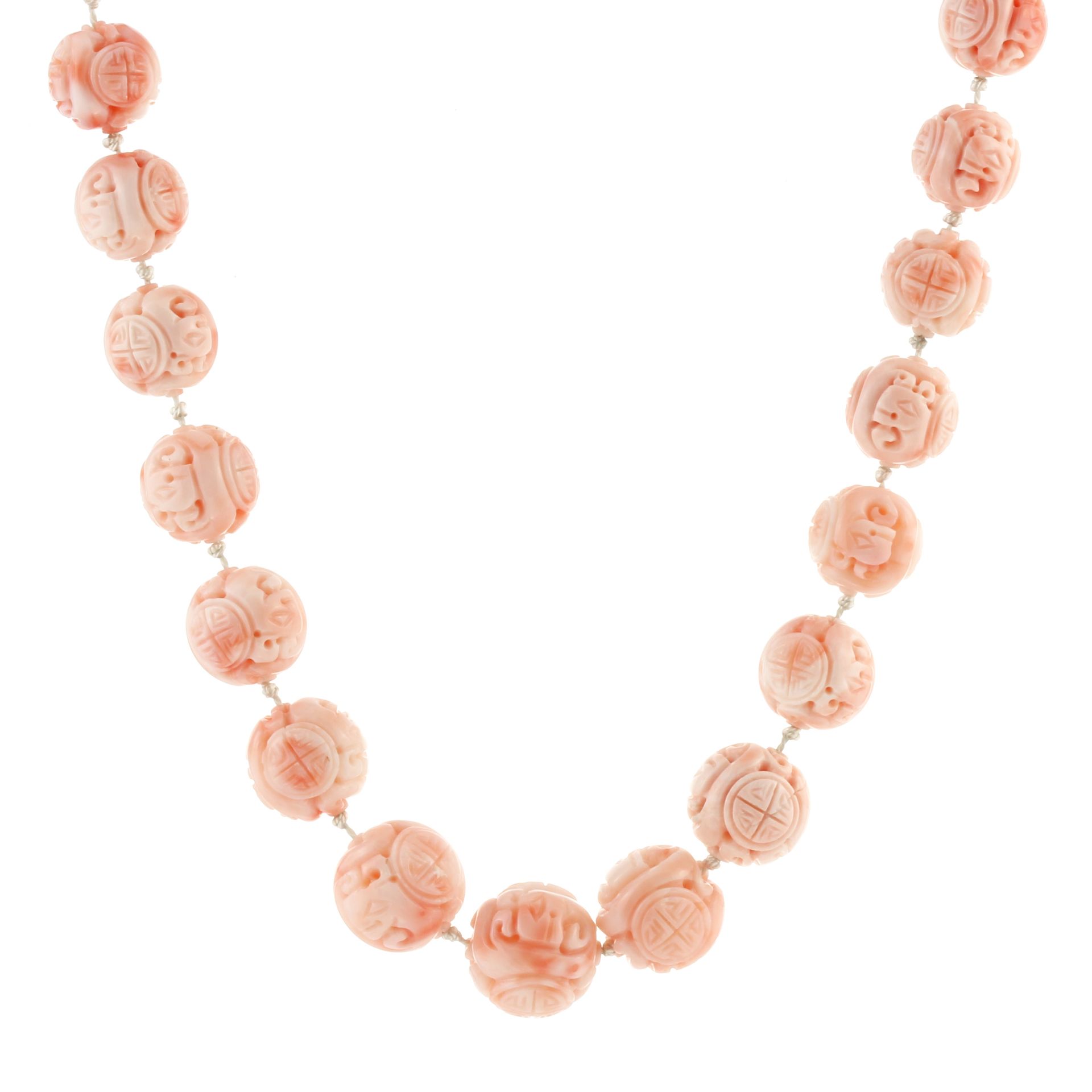 A CHINESE CORAL BEAD NECKLACE comprising a single row of thirty two graduated carved coral beads